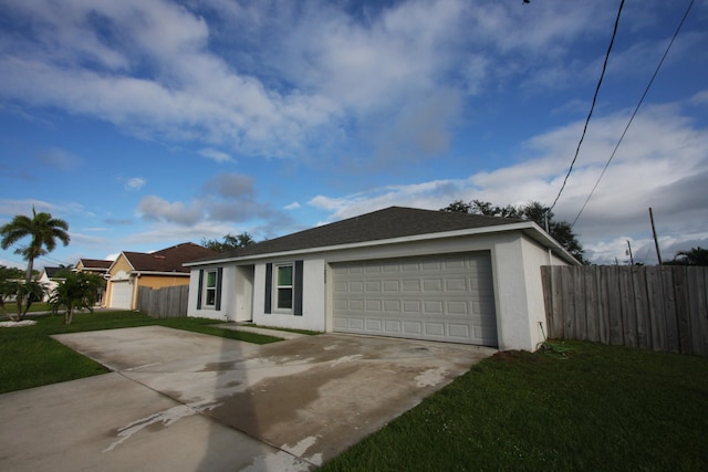 ranch-style home with a front lawn and a garage