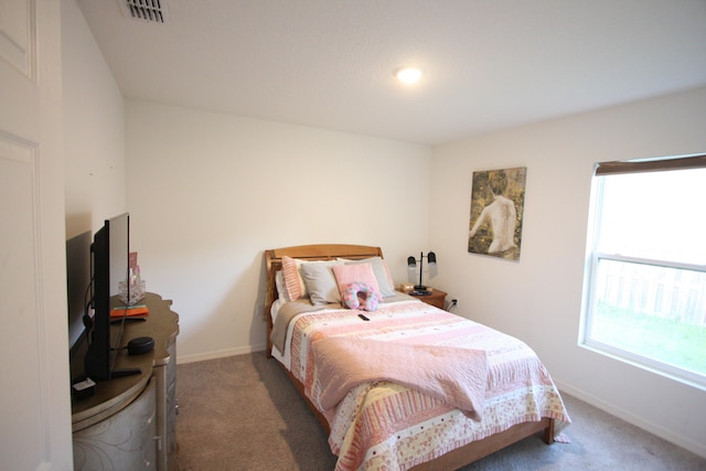 bedroom featuring dark carpet