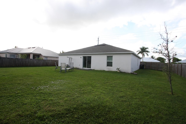 rear view of property with a lawn