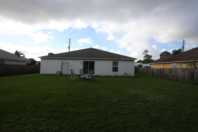 rear view of house with a lawn