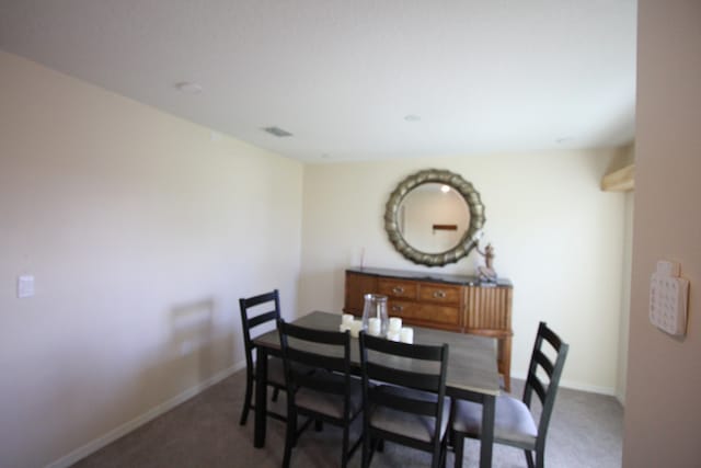 dining room with dark carpet