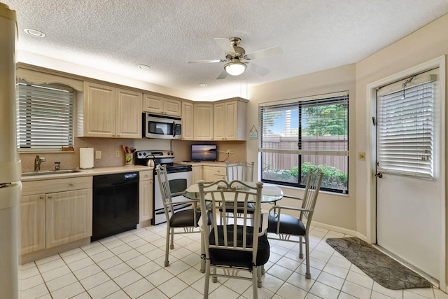 kitchen featuring light tile patterned flooring, ceiling fan, a sink, light countertops, and appliances with stainless steel finishes