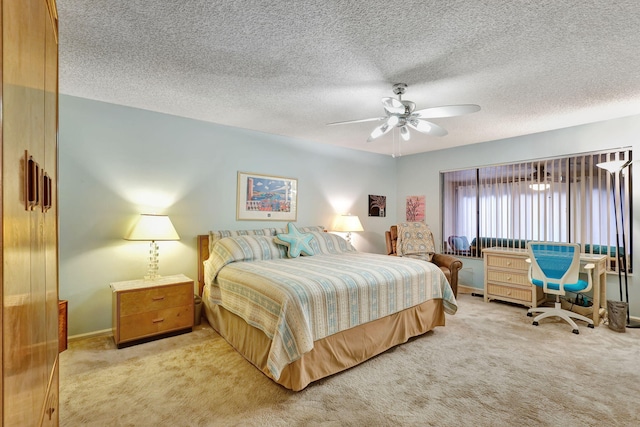 bedroom featuring ceiling fan, a textured ceiling, and light carpet