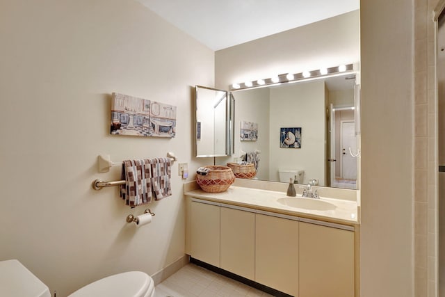 bathroom with baseboards, toilet, and vanity