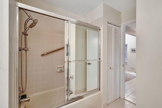 bathroom with a closet and bath / shower combo with glass door