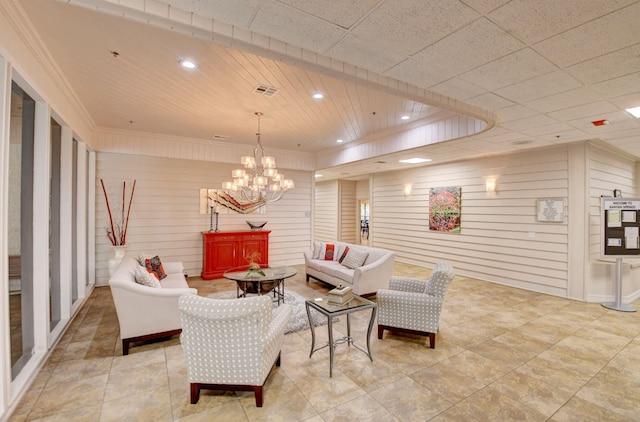 living area featuring an inviting chandelier, recessed lighting, visible vents, and ornamental molding