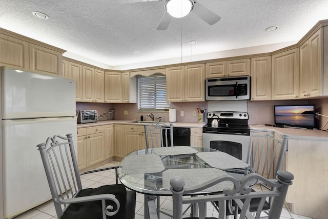 kitchen with light tile patterned floors, a ceiling fan, a toaster, stainless steel appliances, and light countertops