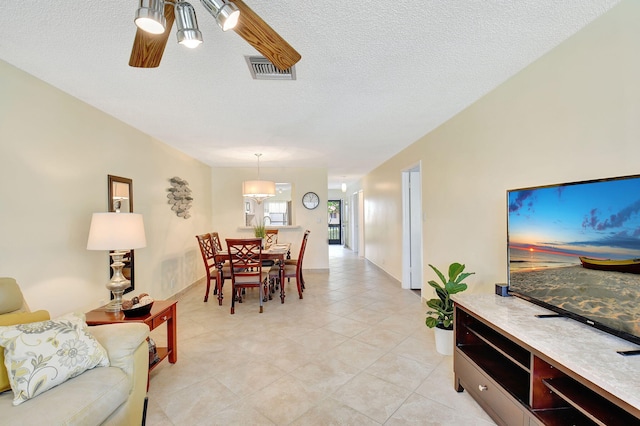 dining space featuring a textured ceiling and ceiling fan