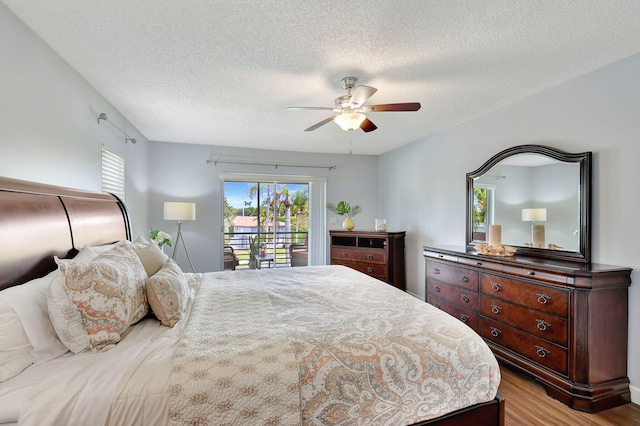 bedroom featuring access to outside, a textured ceiling, ceiling fan, and light hardwood / wood-style flooring