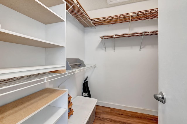 spacious closet featuring hardwood / wood-style flooring