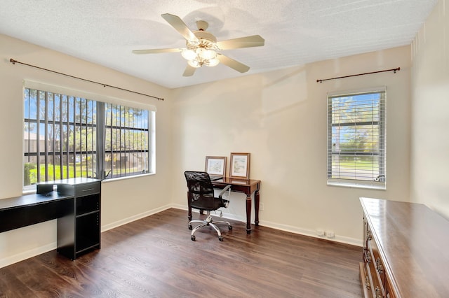 office area featuring a textured ceiling, a wealth of natural light, dark hardwood / wood-style floors, and ceiling fan