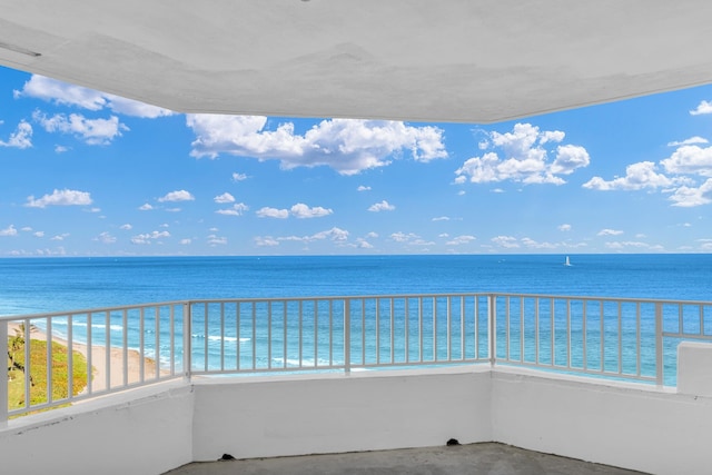 balcony with a beach view and a water view