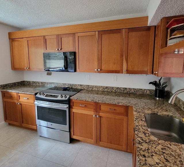 kitchen featuring stainless steel electric stove, dark stone countertops, a textured ceiling, and sink