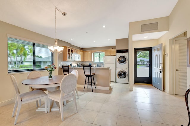 212 Club Dr, Palm Beach Gardens, FL 33418 - dining area featuring stacked washer and clothes dryer, a chandelier, light tile patterned floors, baseboards, and recessed lighting