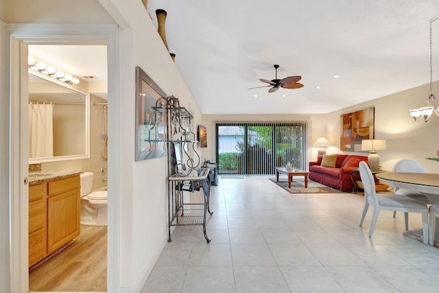 212 Club Dr, Palm Beach Gardens, FL 33418 - living room featuring ceiling fan, vaulted ceiling, a chandelier, and light tile patterned flooring