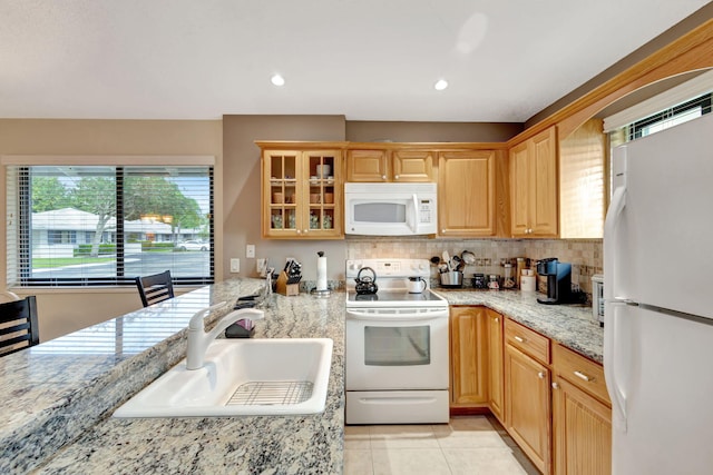 212 Club Dr, Palm Beach Gardens, FL 33418 - kitchen featuring white appliances, a sink, tasteful backsplash, glass insert cabinets, and light tile patterned floors