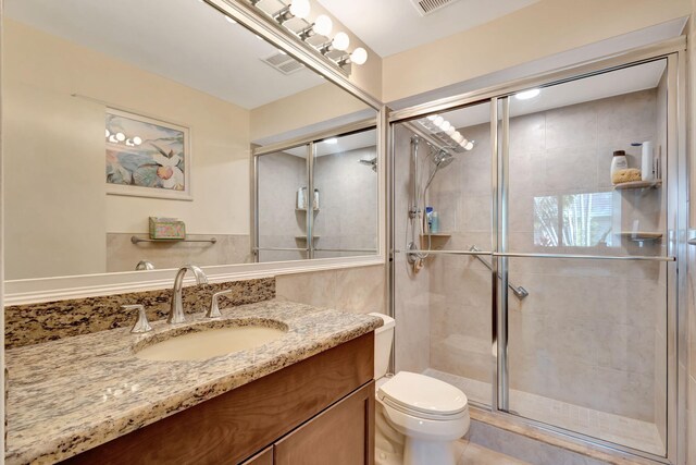 212 Club Dr, Palm Beach Gardens, FL 33418 - bathroom featuring a shower stall, toilet, and vanity