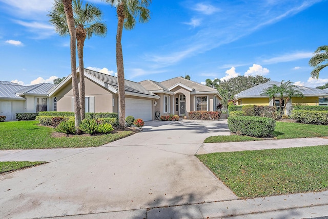 view of front of home featuring a front yard and a garage