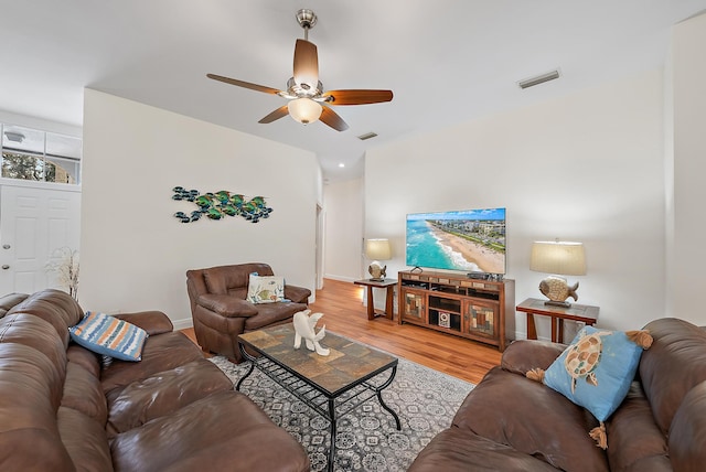 living room featuring light hardwood / wood-style floors and ceiling fan