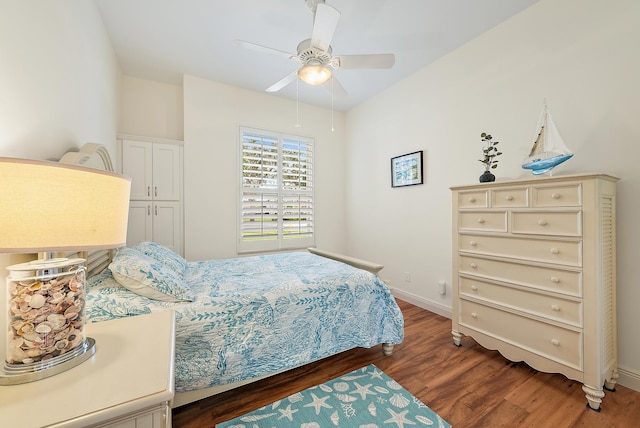 bedroom with ceiling fan and dark hardwood / wood-style floors