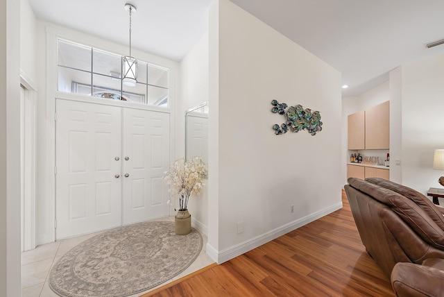 entryway with light hardwood / wood-style floors