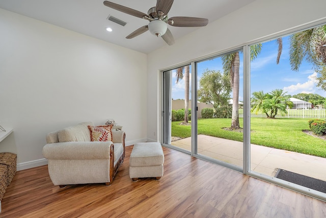 sitting room featuring wood-type flooring and ceiling fan