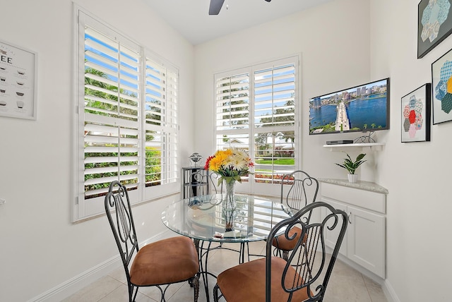 dining space featuring ceiling fan and light tile patterned floors