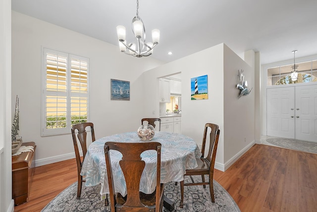 dining area featuring a notable chandelier and light hardwood / wood-style flooring