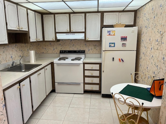 kitchen with exhaust hood, sink, light tile patterned floors, a paneled ceiling, and white appliances