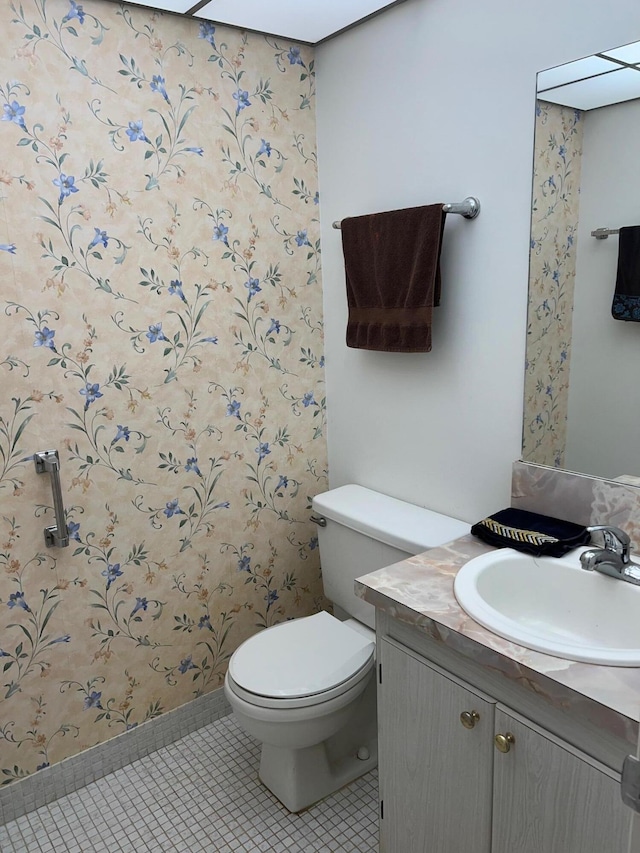 bathroom featuring vanity, toilet, and tile patterned floors