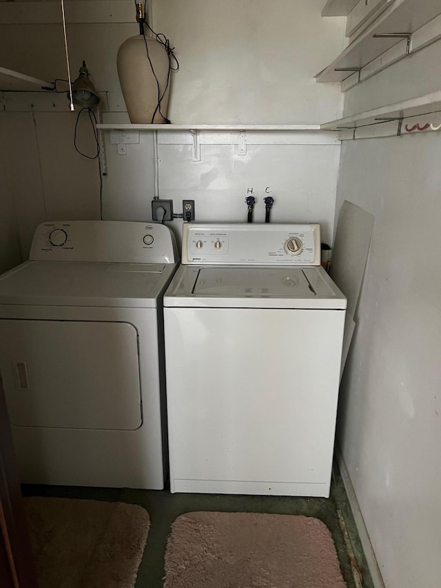 clothes washing area with washer and clothes dryer