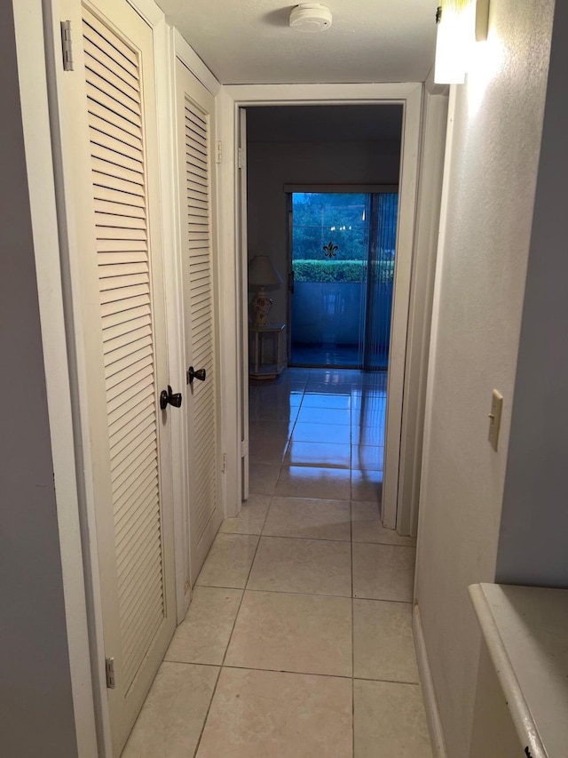 hall with light tile patterned floors