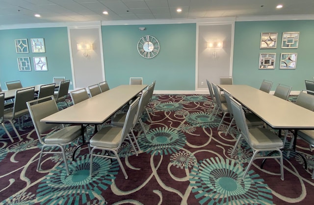 carpeted dining space with ornamental molding