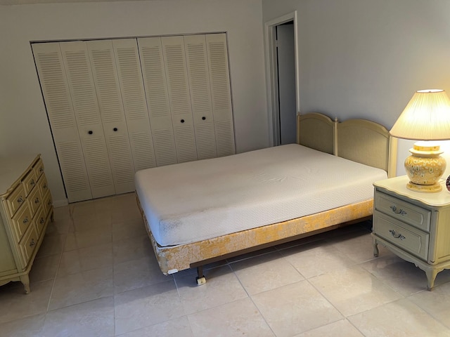 bedroom featuring light tile patterned flooring and a closet