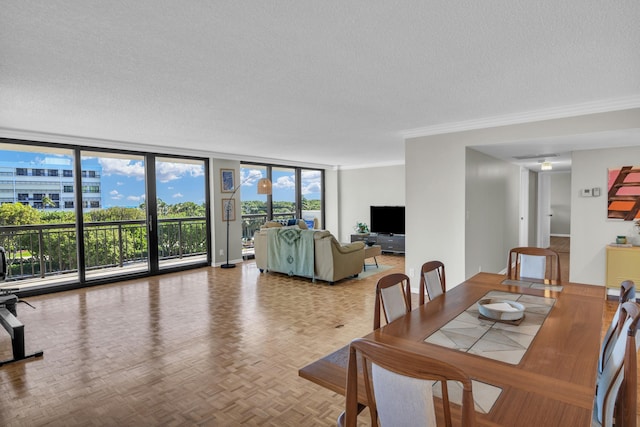 dining room featuring parquet floors, a textured ceiling, expansive windows, and crown molding