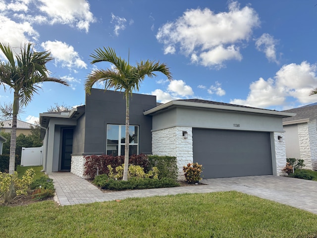 view of front facade with a front yard and a garage