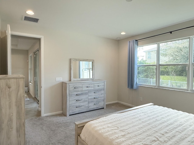 bedroom featuring light colored carpet