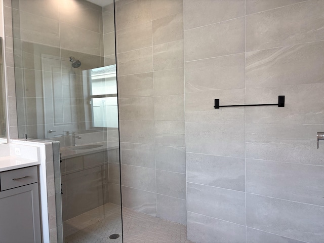 bathroom with vanity and tiled shower