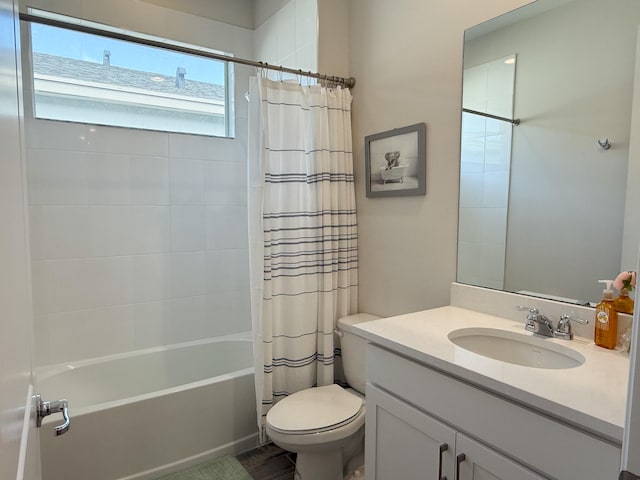 full bathroom featuring shower / bath combo, vanity, and toilet