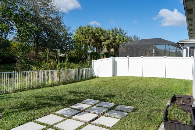 view of yard with glass enclosure