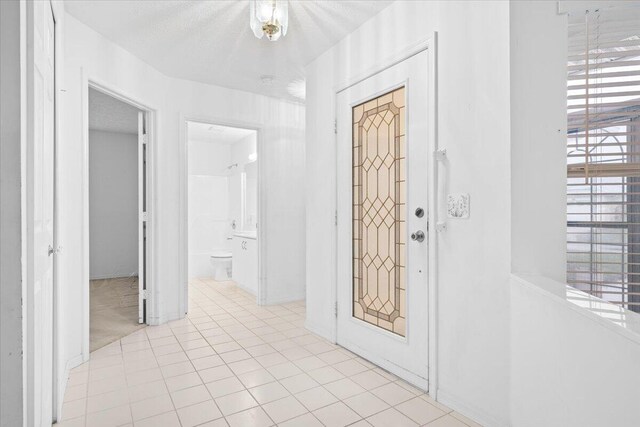 kitchen featuring hanging light fixtures, stainless steel appliances, a notable chandelier, white cabinets, and light hardwood / wood-style floors