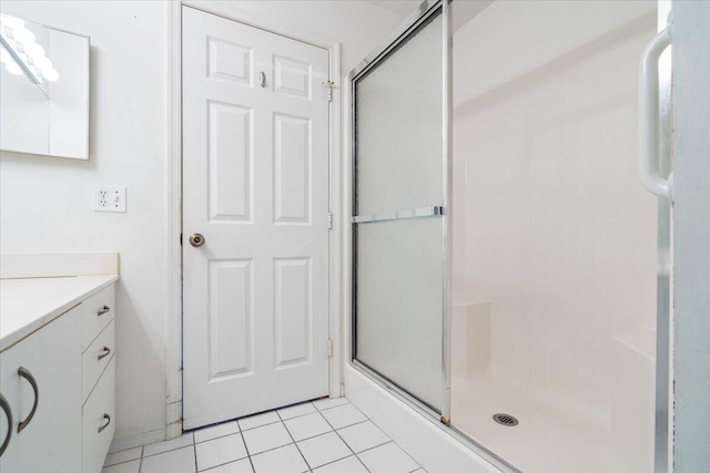 bathroom with vanity, a textured ceiling, walk in shower, and tile patterned floors