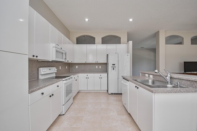 11481 Kanapali Ln, Boynton Beach, FL 33437 - kitchen with white appliances, a sink, tasteful backsplash, white cabinetry, and recessed lighting