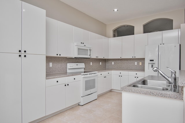 11481 Kanapali Ln, Boynton Beach, FL 33437 - kitchen with white appliances, a sink, backsplash, light countertops, and white cabinets