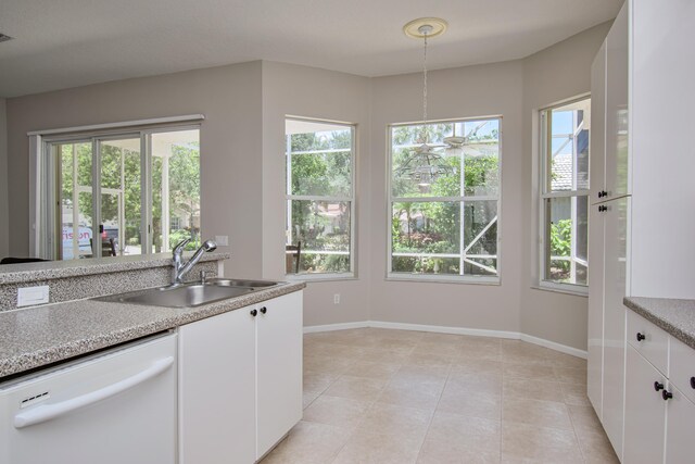 11481 Kanapali Ln, Boynton Beach, FL 33437 - kitchen featuring white dishwasher, a sink, white cabinetry, and plenty of natural light