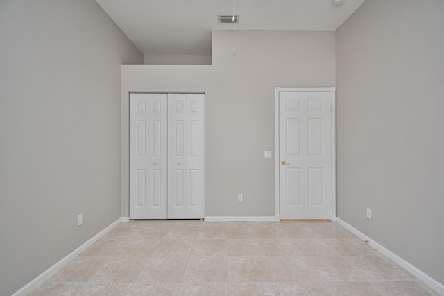 11481 Kanapali Ln, Boynton Beach, FL 33437 - unfurnished bedroom featuring a closet, light tile patterned flooring, and baseboards