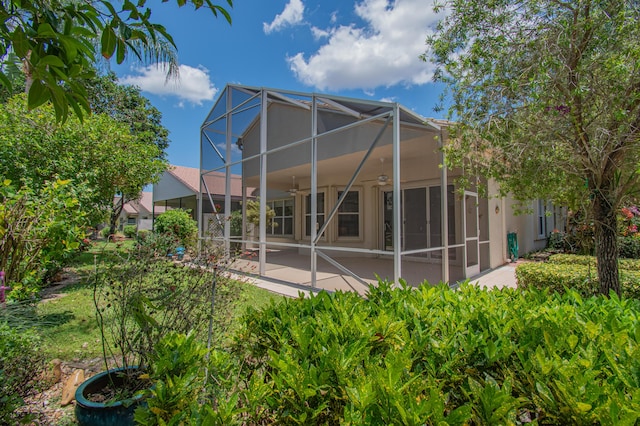 11481 Kanapali Ln, Boynton Beach, FL 33437 - rear view of house featuring a ceiling fan, a patio, stucco siding, and glass enclosure