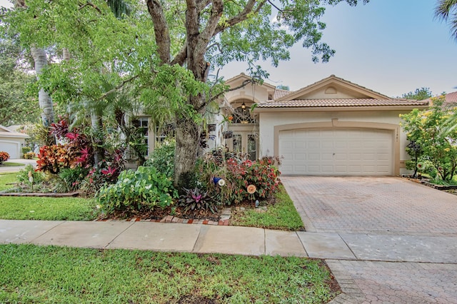 11481 Kanapali Ln, Boynton Beach, FL 33437 - mediterranean / spanish home with decorative driveway, a garage, stucco siding, and a tile roof