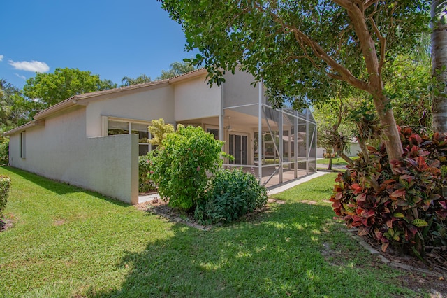 11481 Kanapali Ln, Boynton Beach, FL 33437 - back of house with a yard, stucco siding, a lanai, and a patio