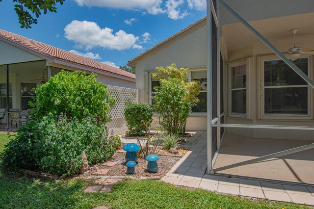 11481 Kanapali Ln, Boynton Beach, FL 33437 - view of yard featuring ceiling fan, a patio area, and a sunroom